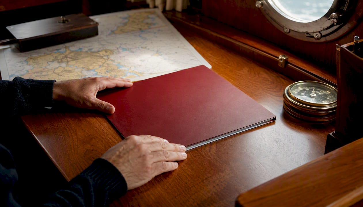 Hands holding yacht registration document folder