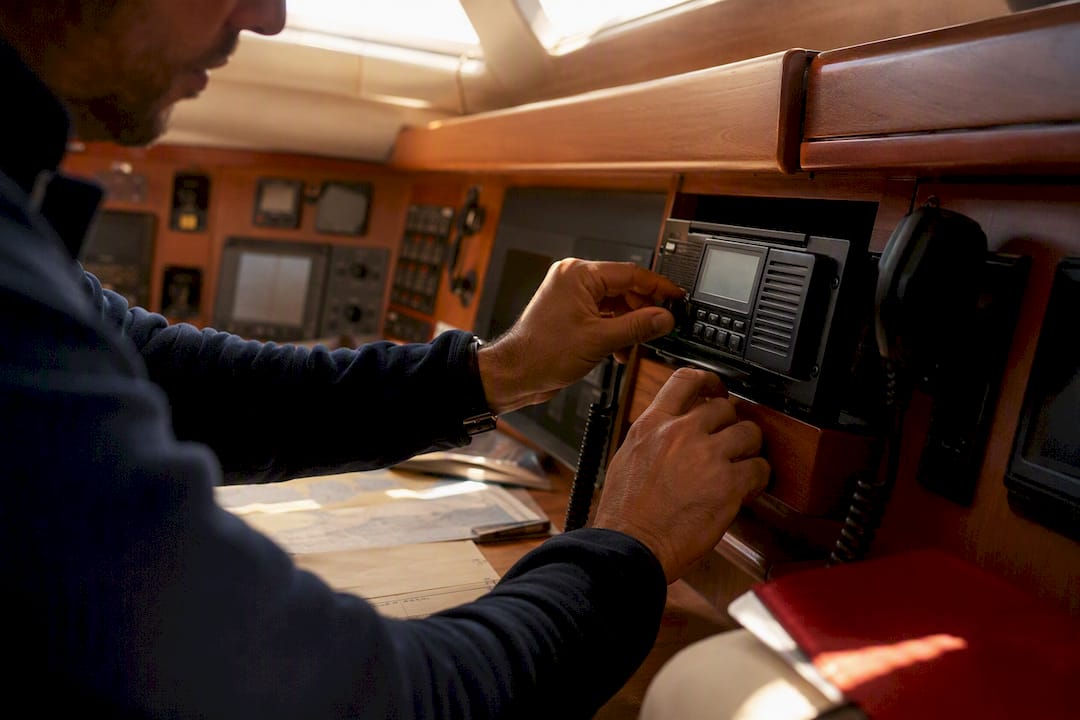 Hands programming yacht VHF radio onboard