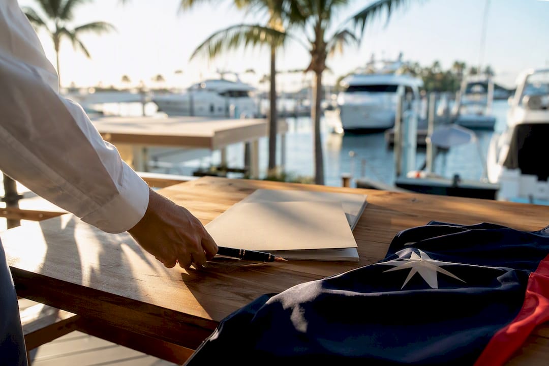 Yacht ownership documents and flag on desk