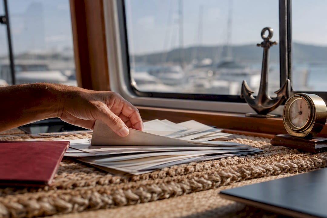 Hand organizing yacht entry documents and receipts