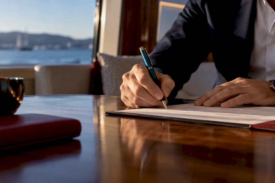 Hands signing yacht bill of sale