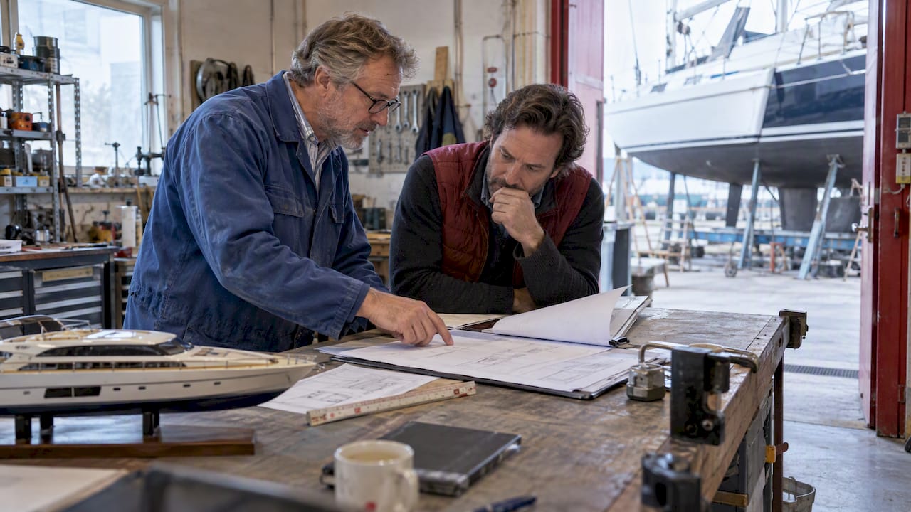 Owner and naval architect comparing vessel measurements