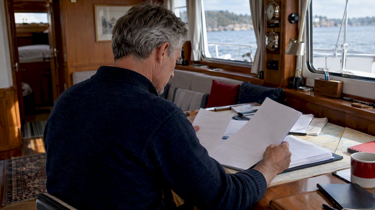 Owner assembling paperwork aboard a yacht