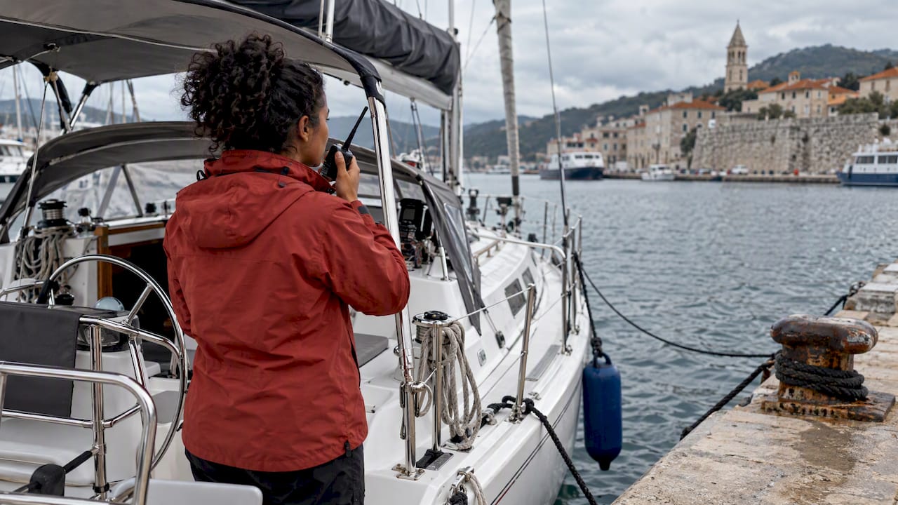 Yacht owner speaking into a marine VHF radio