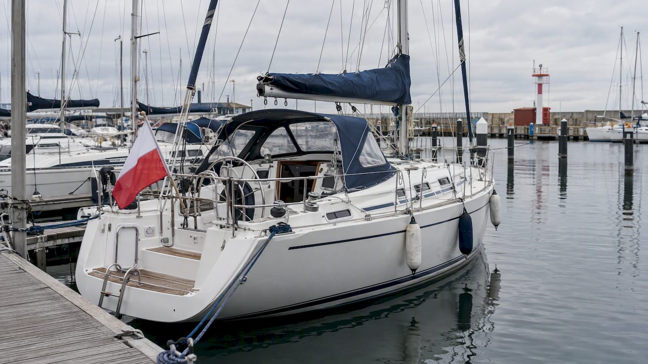 Yacht flying the Polish flag in a marina